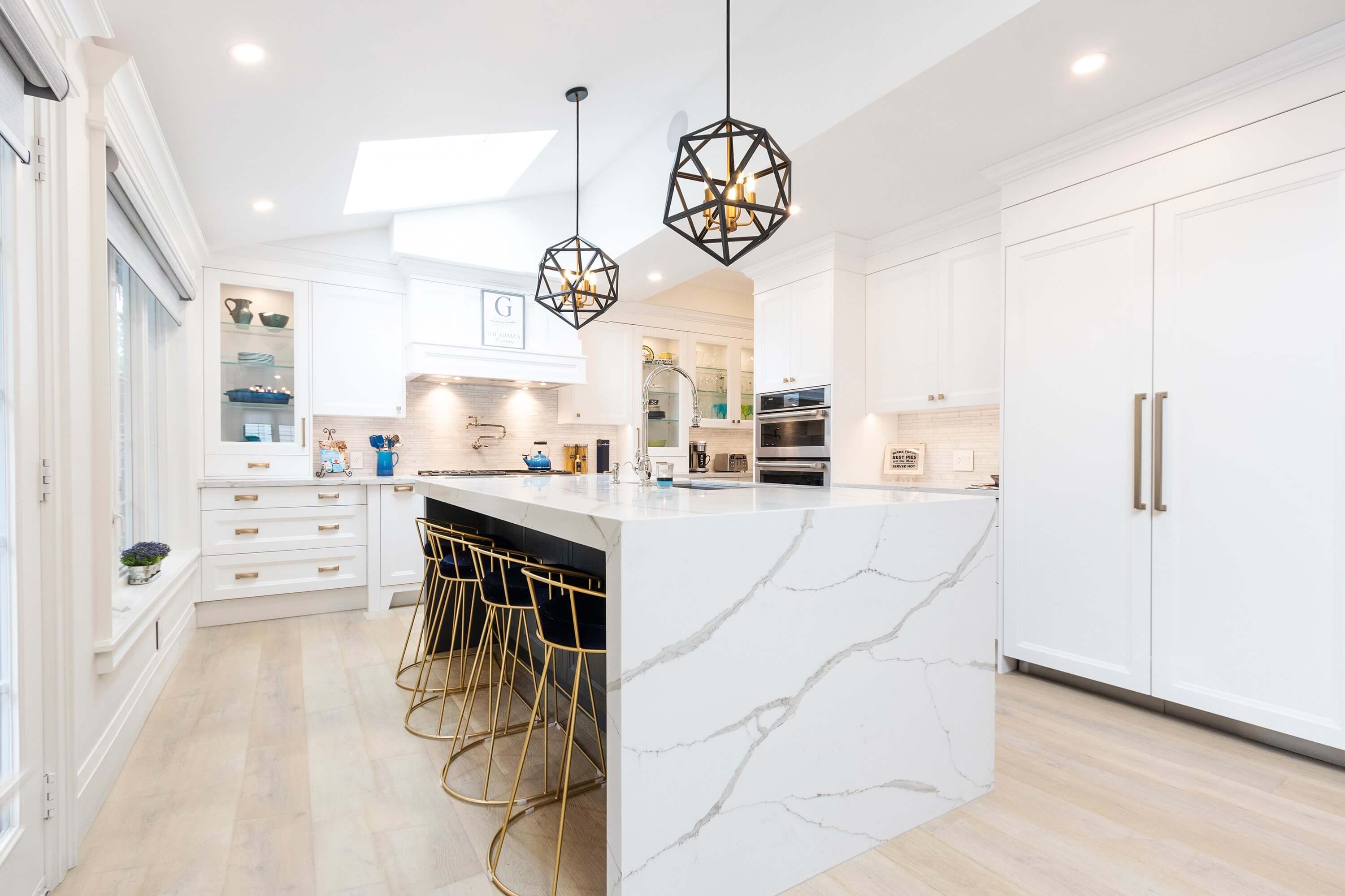 Light-filled kitchen with a veined white waterfall island, from the existing TSF website