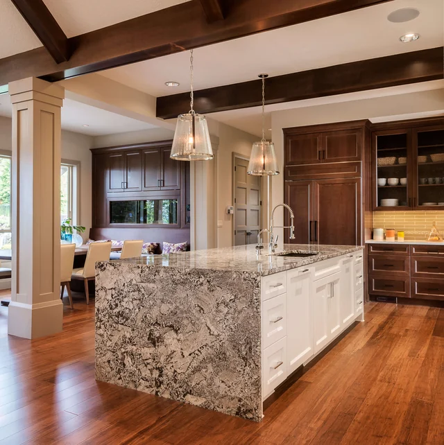 Warm timber kitchen with a richly patterned stone waterfall island