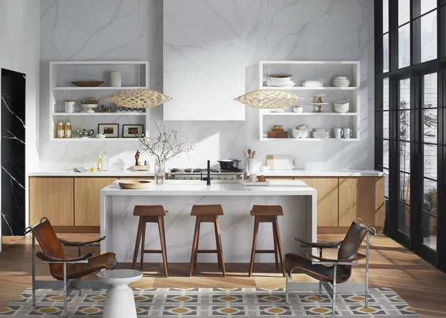Kitchen with a full-height white-and-gold stone wall, timber cabinets and a waterfall island