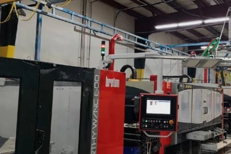 CNC equipment and overhead lifting systems on the TSF fabrication floor.