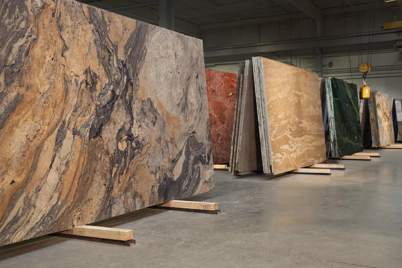 Natural stone slabs in a range of colours and patterns displayed in the showroom.