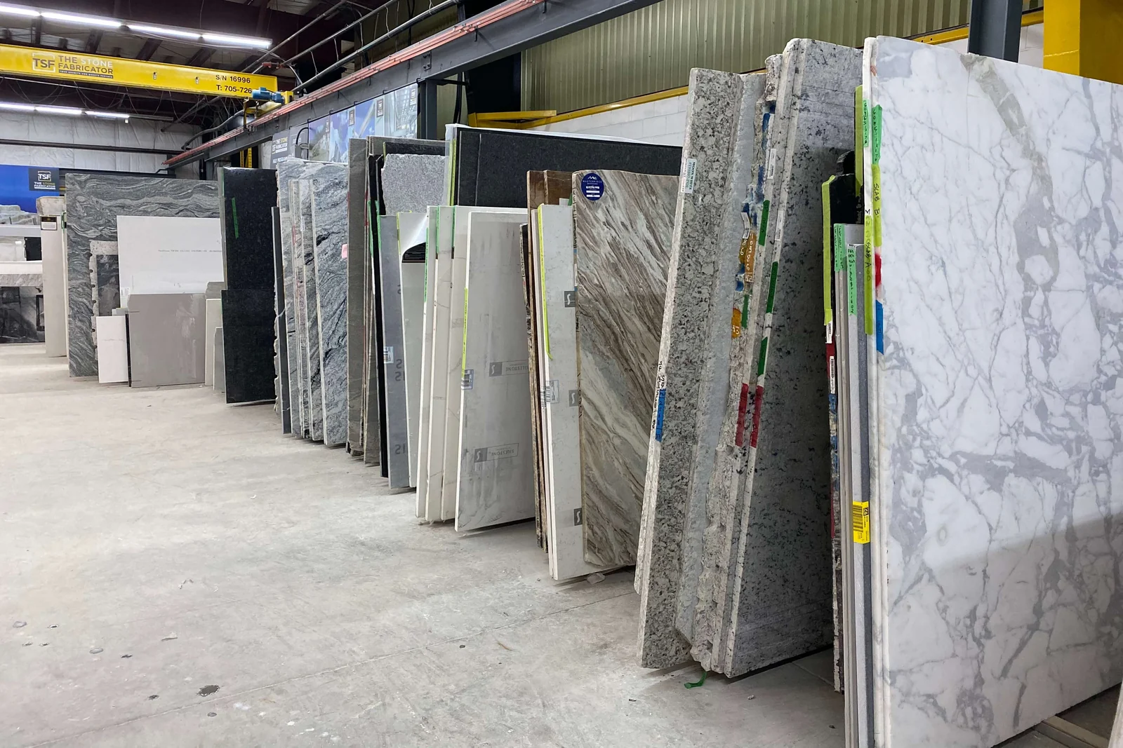 Rows of full stone slabs inside the TSF indoor slab showroom.